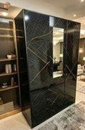 Modern interior with a large black marble cabinet.