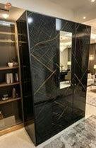 Modern interior with a large black marble cabinet.